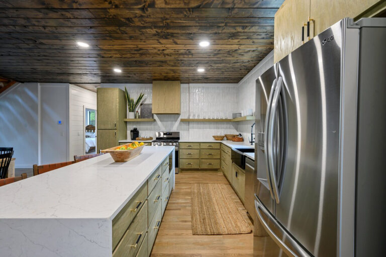 Well-appointed kitchen with warm wood cabinets, granite countertops, and stainless steel appliances.