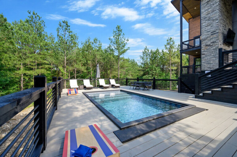 Poolside view showing modern lounge chairs and a clear view of the sparkling water.