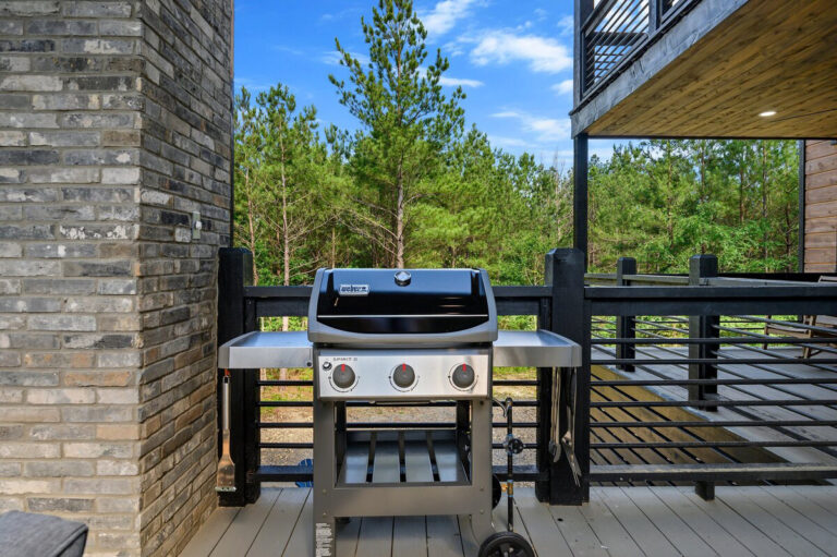 Close-up of the stainless steel outdoor grill on the Aquarius cabin deck, ready for barbecuing.