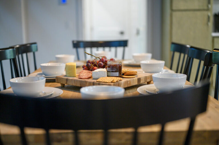 Close-up of a dining table beautifully set with an assortment of fresh, colorful foods and elegant tableware.