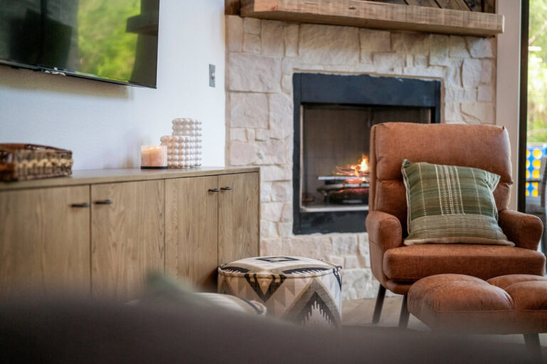 Stylish fireplace set in a modern living room with neutral, earthy tones.