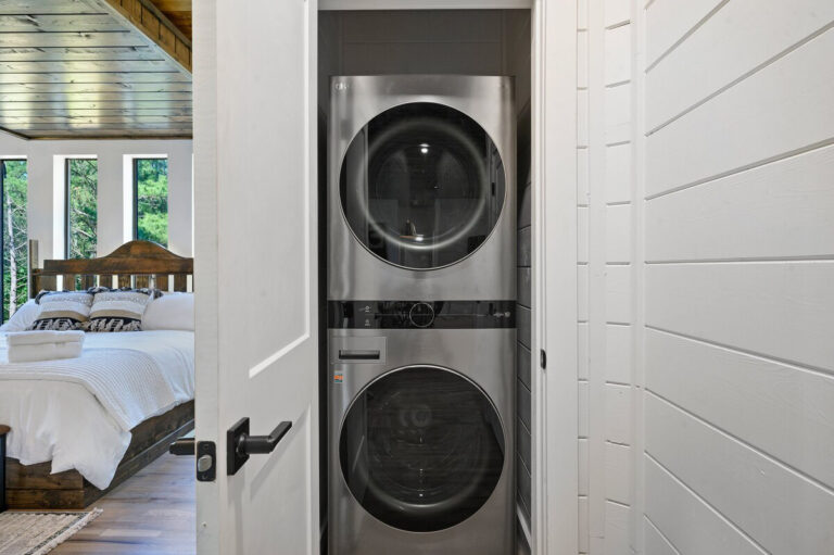 Stackable washer and dryer unit neatly arranged in a compact laundry space.