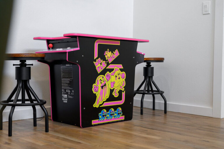 Classic Pac-Man arcade cabinet standing in the game area of the Aquarius cabin.