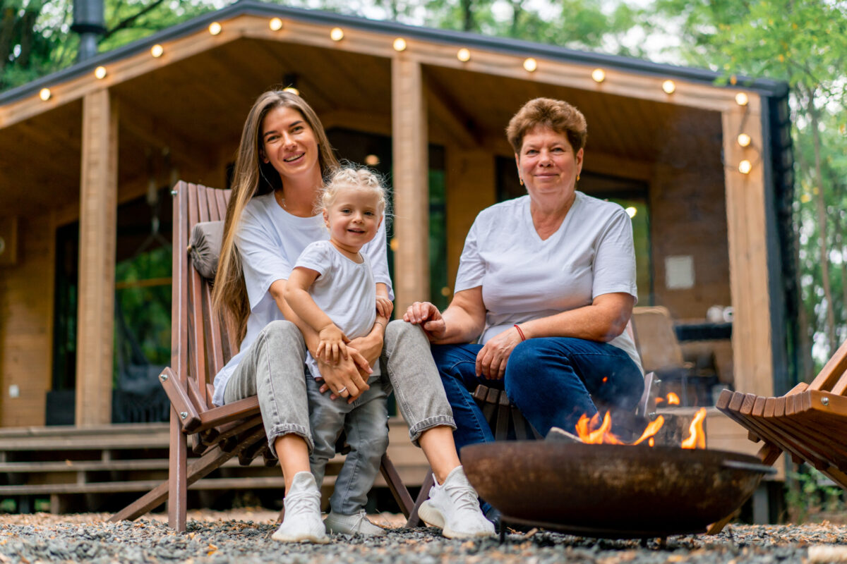 Three generations enjoying time by a fire outside a broken bow investment cabin in oklahoma