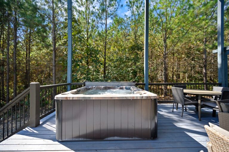 Private hot tub on forest-view deck, ideal for a couple's getaway