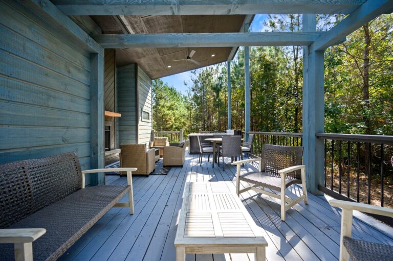 Spacious covered deck with seating and forest views, ideal for a couple's getaway
