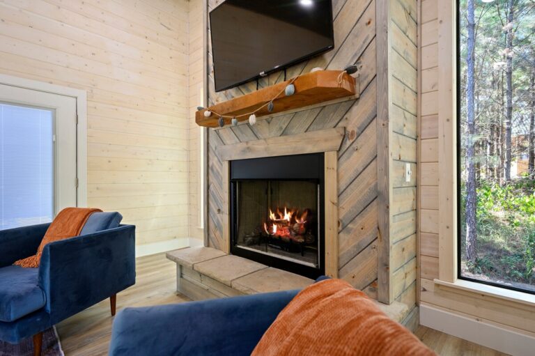 Cozy indoor fireplace with modern seating, ideal for a couple's getaway
