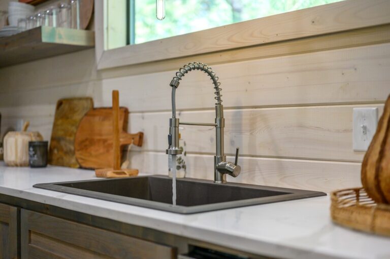 Modern farmhouse sink with gooseneck faucet, ideal for a couple's getaway