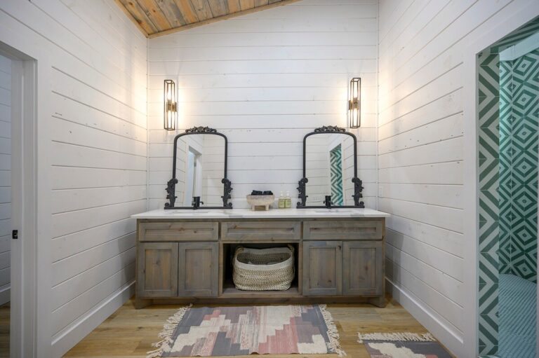 Rustic double vanity with black framed mirrors and wood cabinetry, ideal for a couple's getaway