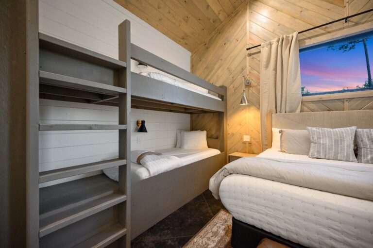 A bright, modern bathroom with dual sinks and sleek fixtures—perfect for large family vacation groups needing space and convenience.