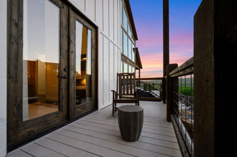 Private cabin deck with rocking chair at sunset, perfect for a large family vacation