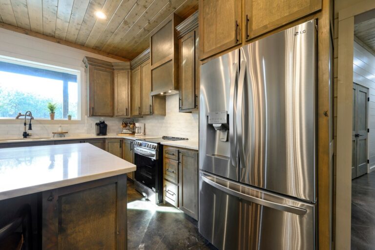 Modern kitchen with stainless steel appliances for a family reunion gathering.