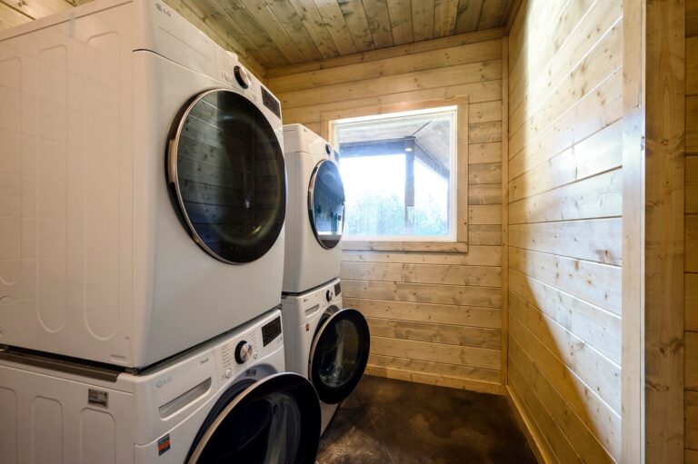 Laundry room with stacked washers and dryers