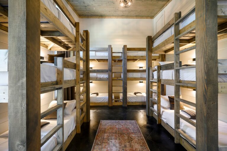 Bunk room with multiple rustic wooden bunk beds