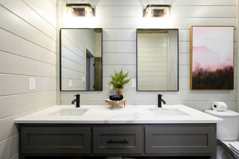 Double vanity bathroom with white countertop and black faucets