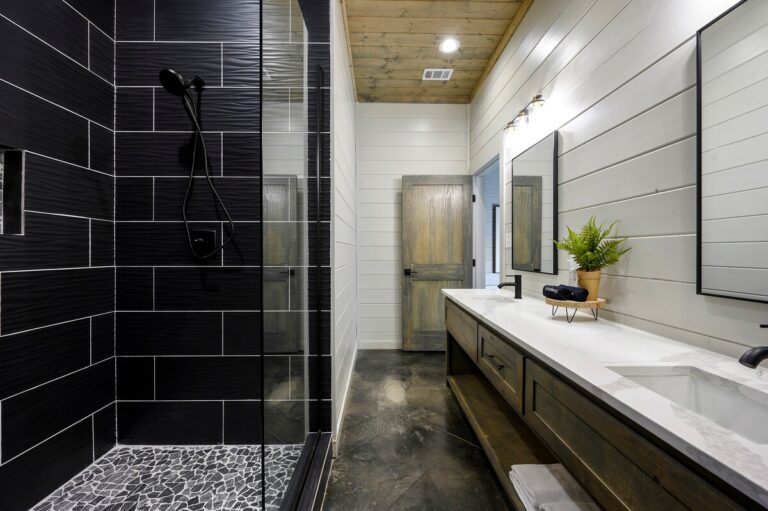 Bathroom with black tile shower and long vanity