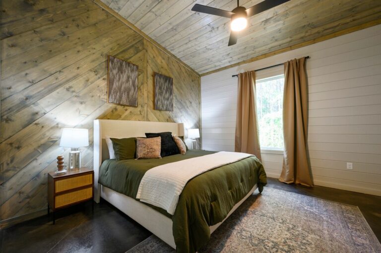 Cozy bedroom with striped bedding, perfect for relaxing during a family reunion getaway.