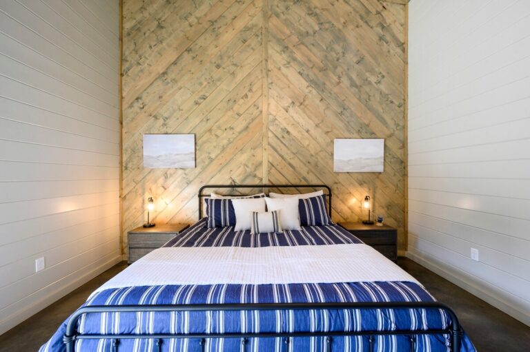 Cozy bedroom with striped bedding, perfect for relaxing during a family reunion getaway.