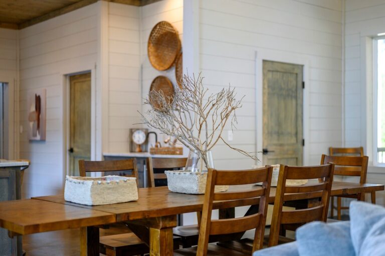 Rustic dining room with wooden table and chairs set for gathering — family reunion meal space