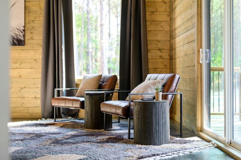Cozy sitting area with leather chairs and forest views — family reunion cabin retreat