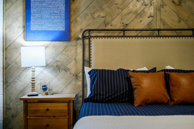 Cozy bedroom with navy and leather accents — perfect for family reunion lodging