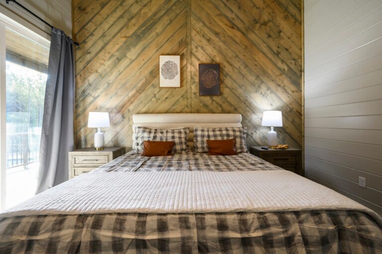 Spacious king bedroom with warm wood accent wall — ideal for family reunion accommodations