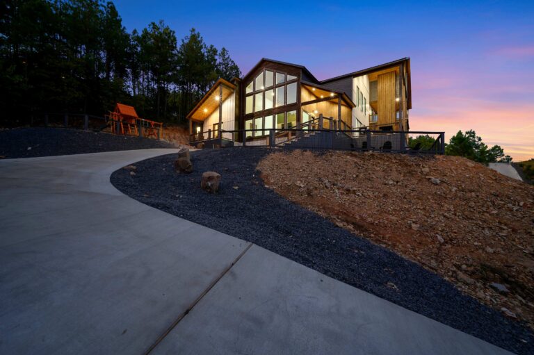 Modern mountain cabin with large windows and playground, ideal for a large family vacation