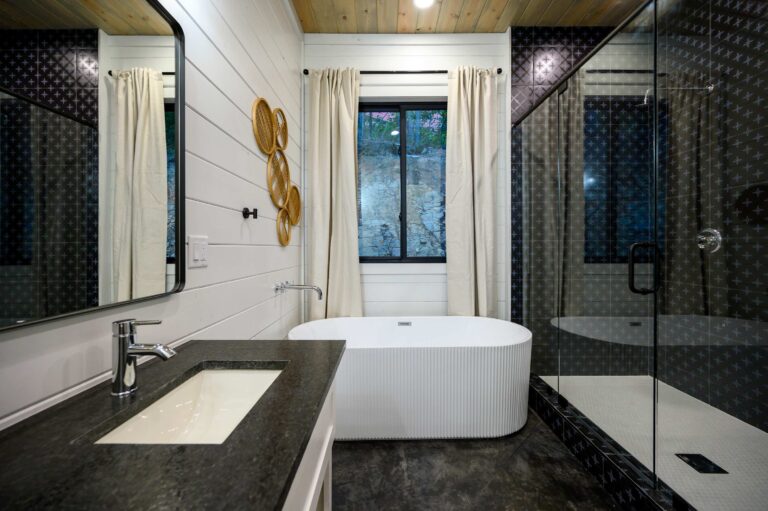 Modern bathroom with tub and walk-in shower for large family vacation rental