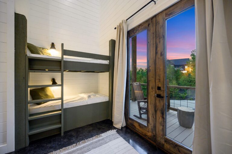 Cozy bunk bed room with private deck access for large family vacation rental