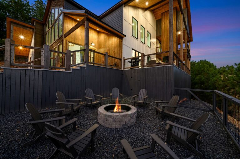 Outdoor fire pit with Adirondack chairs at large family vacation rental