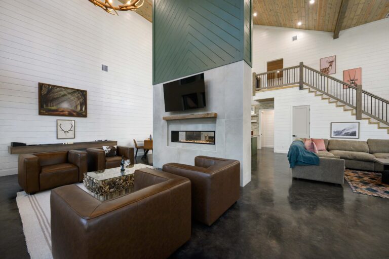 Spacious main living room with fireplace and ample seating for large family vacations