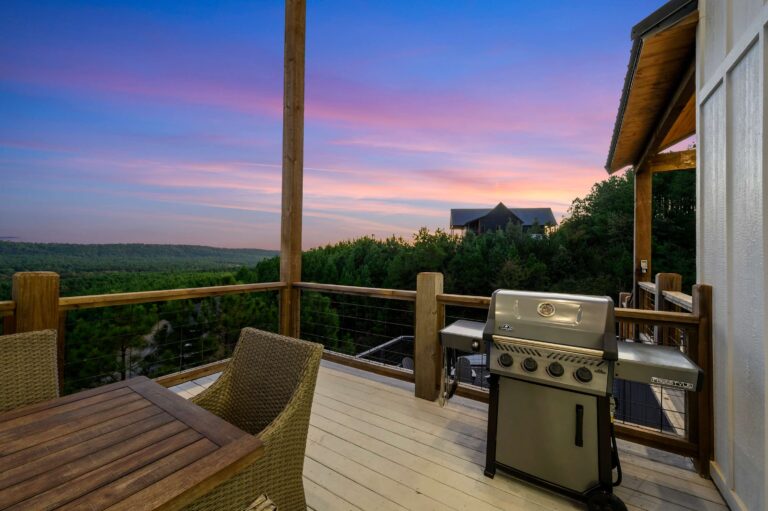 Sunset deck with gas grill and outdoor dining overlooking forest views