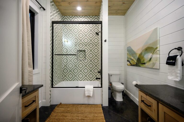 Modern bathroom with geometric tile shower and black trim