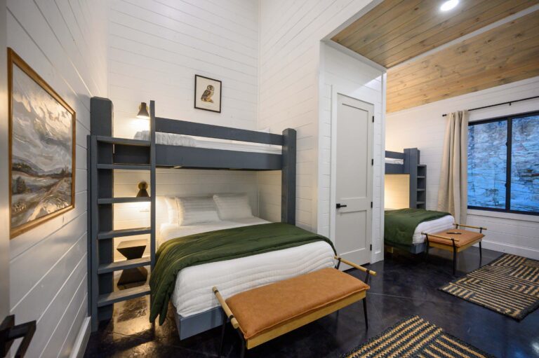 Cozy bunk bedroom with wood accents and green bedding