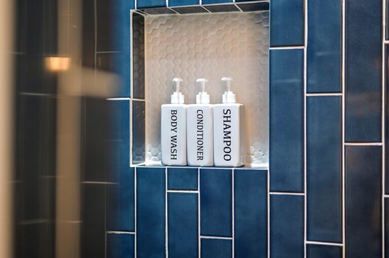 Blue tile shower niche with toiletries for family vacation ideas to experience nature and enjoy river activities