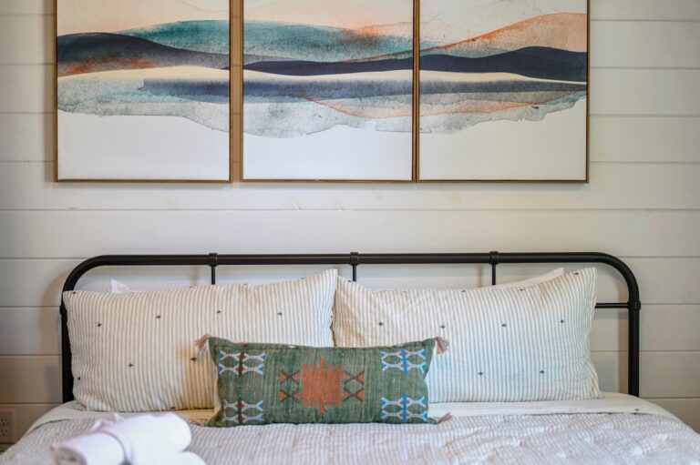 Splish Splash bedroom bed with striped pillows for family vacation ideas, rest after river activities, and cozy ways to experience nature.