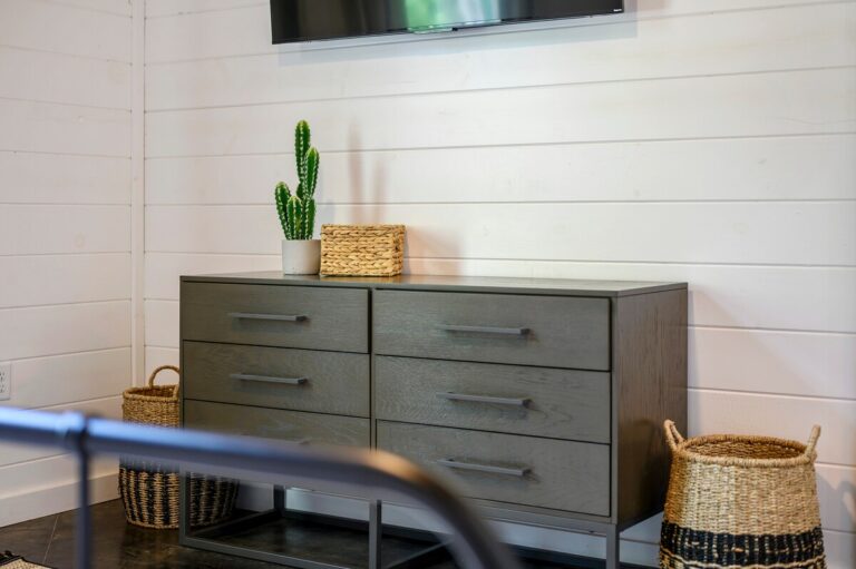 Splish Splash bedroom dresser with cactus plant, offering family vacation ideas, relaxation after river activities, and stylish ways to experience nature.