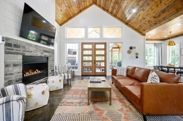 Splish Splash cabin living area with fireplace for family vacation ideas, relaxation after river activities, and cozy ways to experience nature.