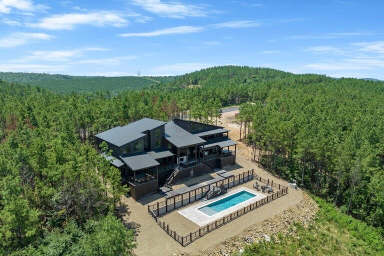 Aerial view of pet friendly cabin with pool, outdoor fire pit, and stargazing setting