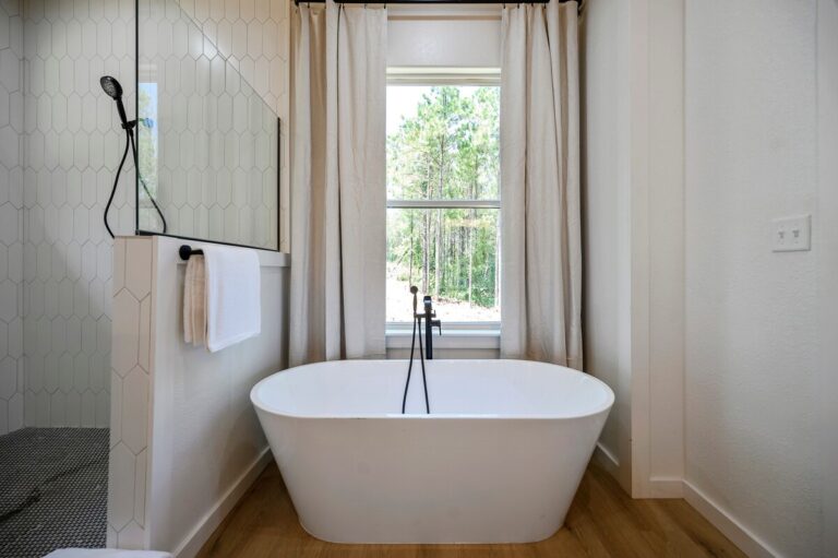 Bathroom with soaking tub and window view at Sky Dive cabin, perfect for unwinding after stargazing nights.