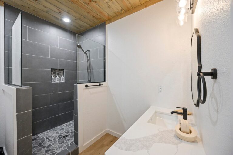 Bathroom with gray tile shower and vanity perfect for stargazing getaways