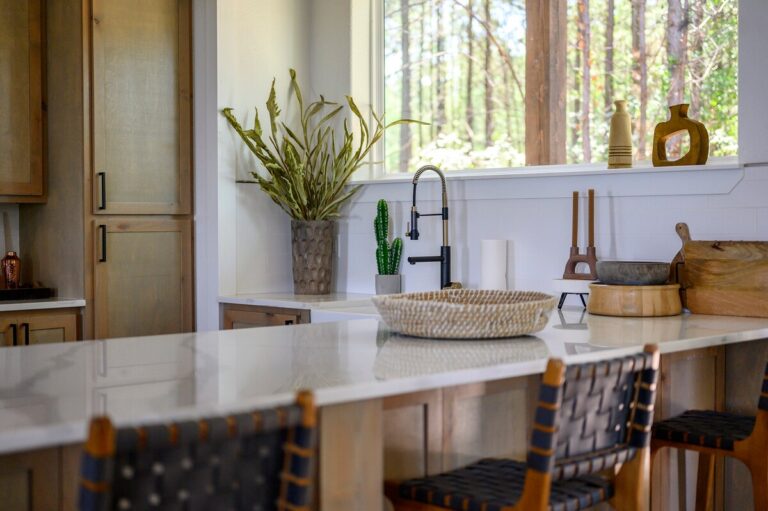 Kitchen island with woven stools and decor in Sky Dive pet friendly cabin, perfect for family meals before evenings of stargazing by the outdoor fire pit.