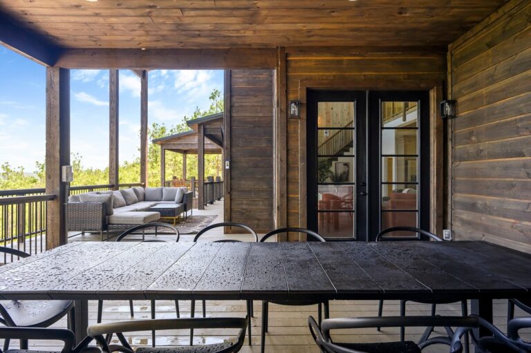 Outdoor dining table on a covered porch with views, perfect for meals and stargazing.