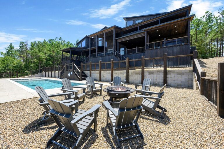 Poolside firepit with Adirondack chairs for evening gatherings and stargazing.