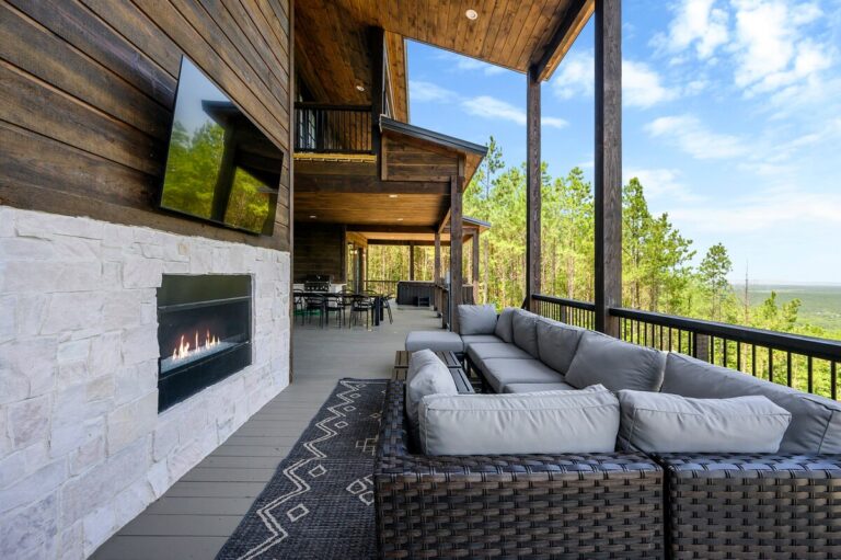 Covered deck with outdoor fireplace, lounge seating, and views for stargazing.