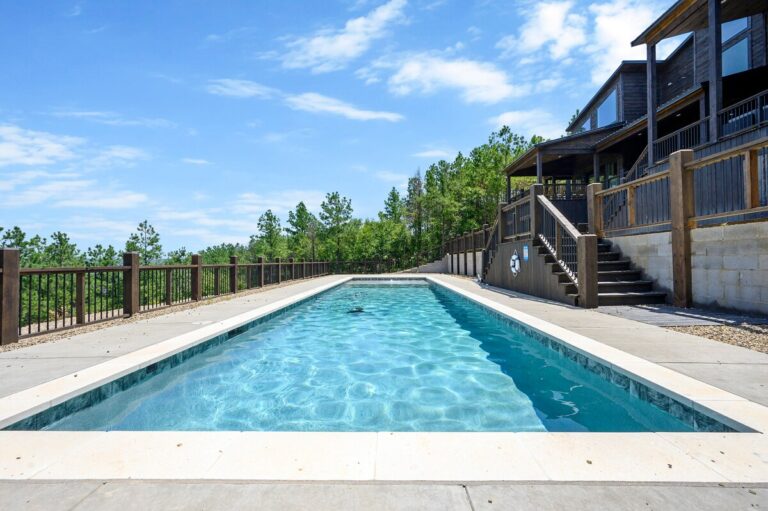 Modern pool with forest backdrop, ideal for daytime swims and stargazing evenings.