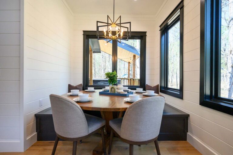 Dining area inside Blue Note Broken Bow cabin with modern table setting near top river activities and outdoor fire pit adventures.