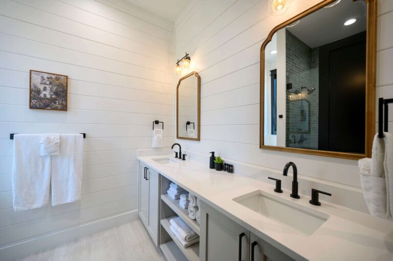 Luxury bathroom vanity inside Blue Note Broken Bow cabin featuring double sinks and modern finishes near outdoor fire pit and river activities.