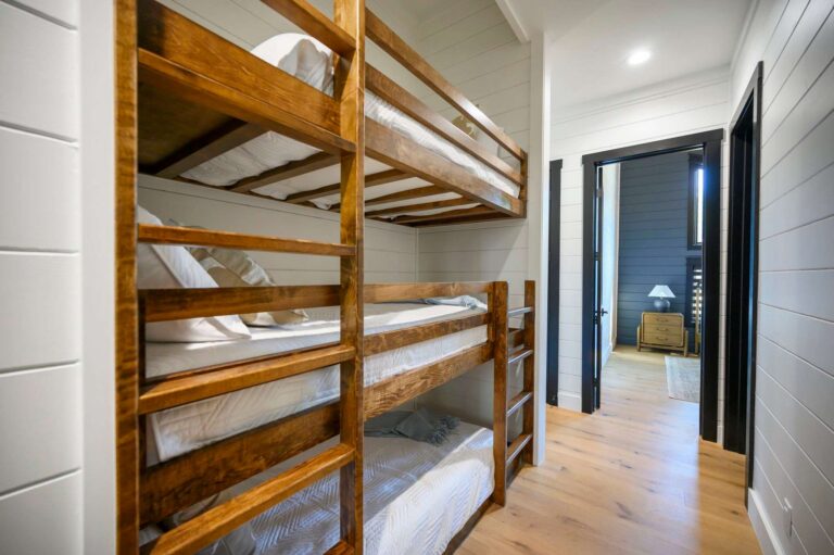 Built-in wooden bunk beds inside Blue Note Broken Bow cabin with cozy sleeping spaces for large group vacations and family stays.