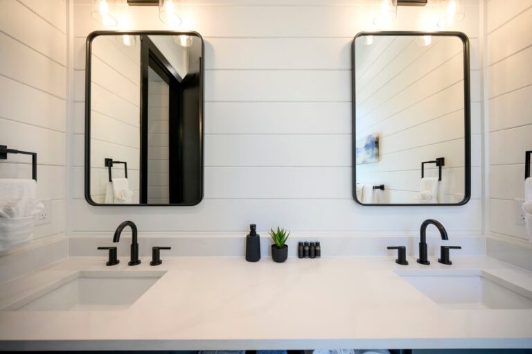 Luxury double vanity bathroom at Blue Note Broken Bow cabin with modern fixtures and spa-inspired design near outdoor fire pit.